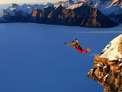 man jumping at cliff under golden hour thumbnail