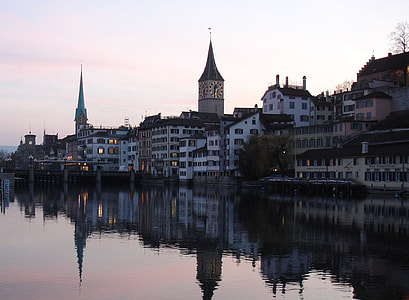 white and brown concrete buildings near body of water thumbnail