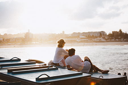 man and woman sitting on floors thumbnail