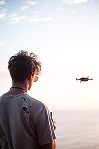 man controlling drone at daytime thumbnail