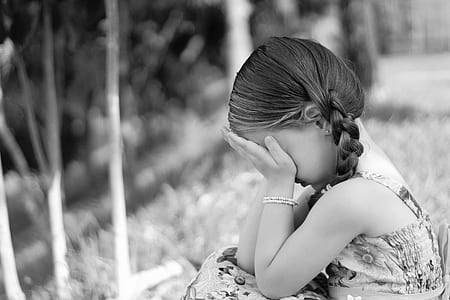 grayscale photo of girl holding her face thumbnail