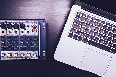 Audio Mixer beside MacBook Pro thumbnail
