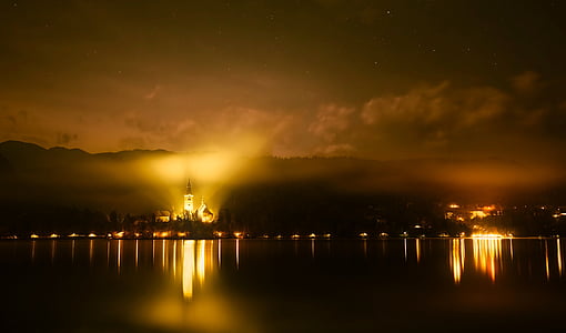 photo of lighted building and calm body of water thumbnail