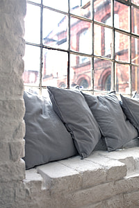 four gray throw pillows by the window thumbnail
