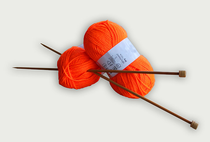 brown hook on orange yarn