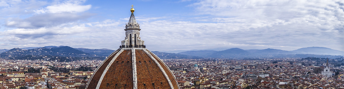 brown cathedral under blue and white sky during daytime thumbnail