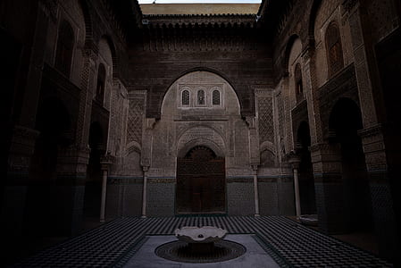 beige and brown concrete building interior with fountain thumbnail