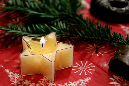 star-shaped clear glass tealight holder on red surface thumbnail