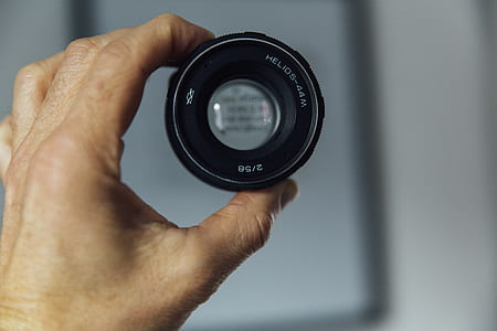 person holding black lens thumbnail