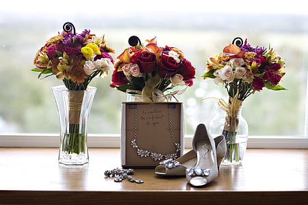 pair of beige heels beside three assorted vases thumbnail