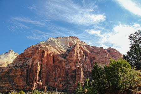 brown rocky mountain under cloudy sky thumbnail