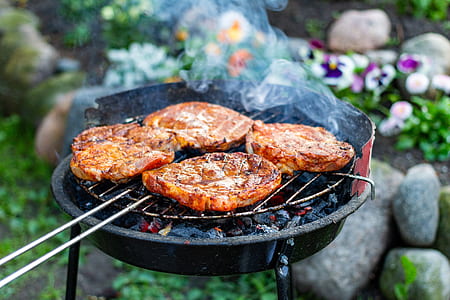 four meat slices being grilled thumbnail