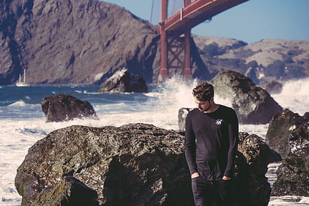 man wearing black long-sleeved shirt under golden gate bridge thumbnail
