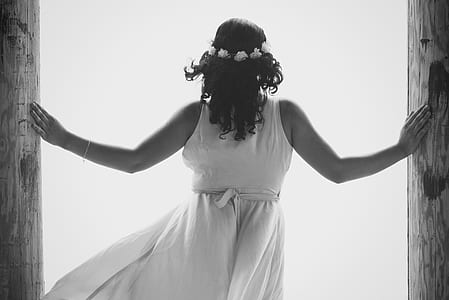 grayscale photo of woman between door thumbnail