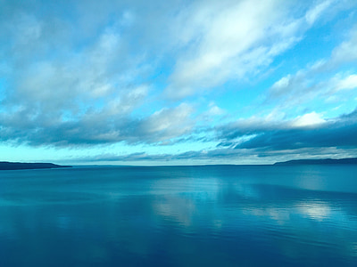 ocean under white clouds during daytime thumbnail
