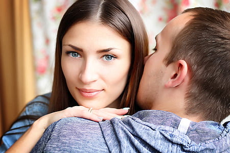 woman with red lips beside man kissing the hair of the girl inside the room thumbnail