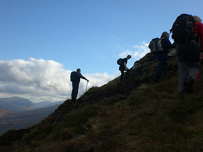 four person hiking on mountain thumbnail