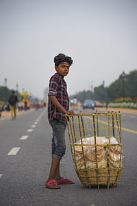 Boy Touching Brown Rattan Basket In The Middle Of Road thumbnail