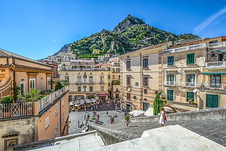 people standing near beige houses thumbnail