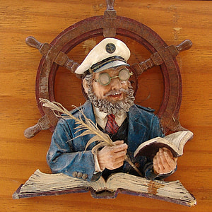 man holding ink pen and book wall decoration on brown wood thumbnail
