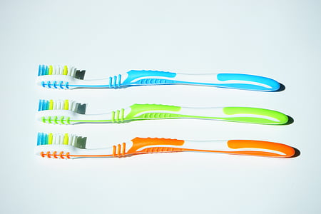 three assorted-color toothbrushes thumbnail