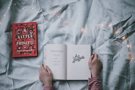 top view photo of person holding open book thumbnail