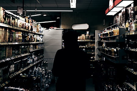 man standing near racks inside building thumbnail