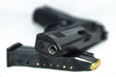 close up photography of black semi-automatic pistol and mag thumbnail