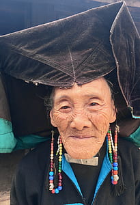 woman wearing black zip-up jacket and black cap thumbnail