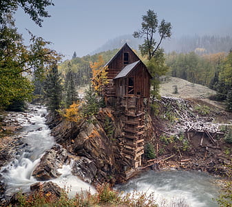 brown wooden cabin on cliff thumbnail