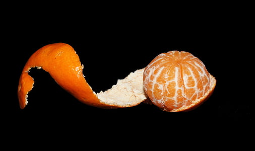 peeled orange fruit in black background thumbnail