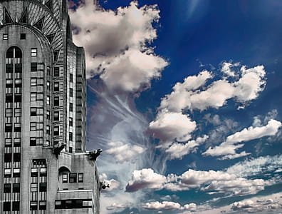 photo of gray concrete building under cloudy sky thumbnail