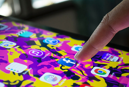 Man checking Facebook app on his iPhone mobile smartphone thumbnail