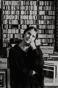 woman on library with her hand on her cheek thumbnail