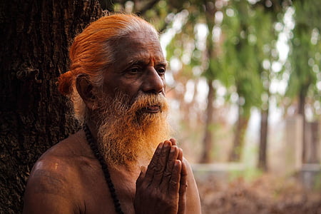 macro photography of bearded man praying thumbnail