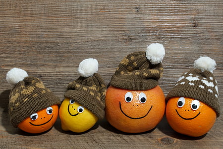 three orange fruits and one yellow citrus with bobble caps thumbnail