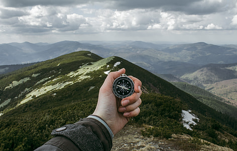 person holding compass thumbnail