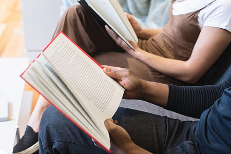 person holding white and red book thumbnail
