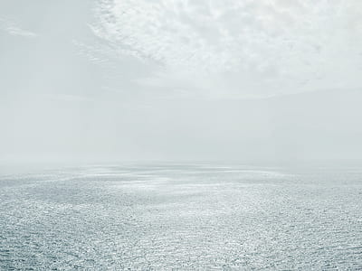 body of water under cloudy sky thumbnail