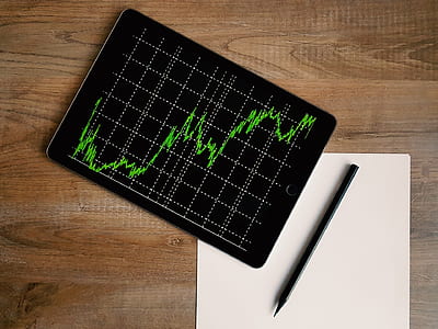 space gray iPad with graph and style pen on brown surface thumbnail