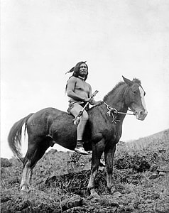 grayscale photo of man riding horse thumbnail