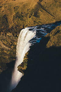 waterfalls surrounded by green grass thumbnail