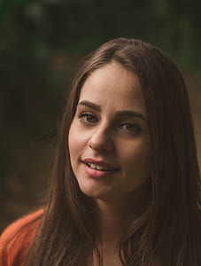 close up photo of woman wearing red top thumbnail