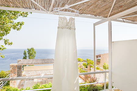 women's white strapless wedding dress hanged on white clothes hanger thumbnail