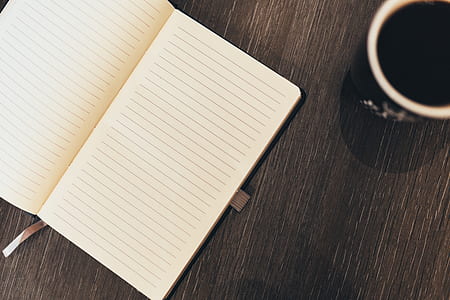 white book beside black ceramic mug thumbnail