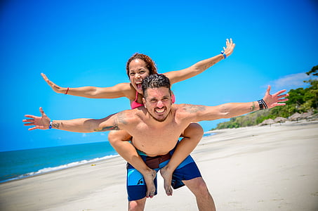woman riding on the back of the man thumbnail
