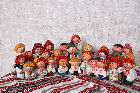 figurines on red and white textile near gray wall thumbnail
