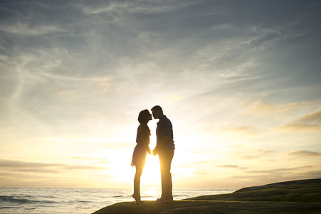 silhouette of couple standing on beach during daytime thumbnail