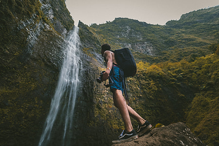 man looking at waterfalls thumbnail