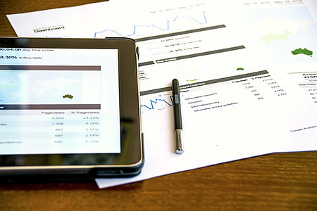 black tablet computer near stylus on printer paper thumbnail